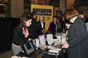 Photo of attendees checking out the resources displayed by staff from the National Center for Victims of Crime at the 2011 National Observance and Candlelight Ceremony.