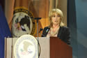 Photo of Joye E. Frost, Acting Director, Office for Victims of Crime, welcoming attendees to the 2011 National Observance and Candlelight Ceremony.