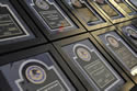 Photo of the 2011 National Crime Victims’ Service Awards plaques displayed on a table.