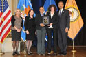 Photo of Shameeka Mattis and Danielle Sered accepting the Award for Professional Innovation in Victim Services on behalf of Common Justice with (from left) Joye E. Frost, Acting Director, Office for Victims of Crime; Acting Assistant Attorney General Mary Lou Leary, Office of Justice Programs; and U.S. Attorney General Eric H. Holder, Jr.