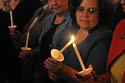 Attendees at the 2009 NCVRW Candlelight Observance pass the candle flame to each other.