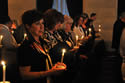 With candles lit, individuals attending the 2009 NCVRW Candlelight Observance participate in a moment of silence.