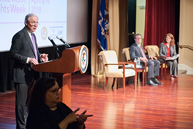U.S. Attorney General Jeff Sessions speaks at the 2018 National Crime Victims' Service Awards Ceremony as OVC Director Darlene Hutchinson and Principal Deputy Assistant Attorney General for the Office of Justice Programs Alan Hanson look on.