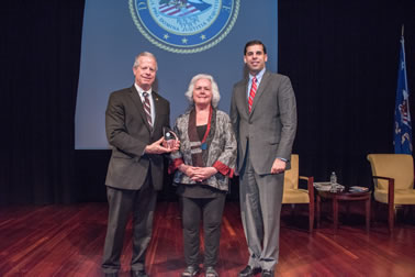 Daniel Reingold accepts the 2017 National Crime Victim Service Award on behalf of Joy Solomon, Esq. with (from left) Acting OVC Director Marilyn McCoy Roberts and Acting Associate Attorney General Jesse Panuccio.