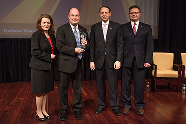 Mark J. Weiner receives the 2019 National Crime Victim Service Award with (from left) OVC Director Darlene Hutchinson, Deputy Attorney General Rod J. Rosenstein, and Principal Deputy Assistant Attorney General for the Office of Justice Programs Matt M. Dummermuth.
