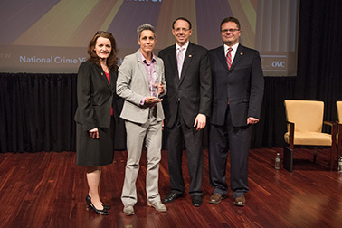 Sergeant Amy Dudewicz receives the 2019 Allied Professional Award with (from left) OVC Director Darlene Hutchinson, Deputy Attorney General Rod J. Rosenstein, and Principal Deputy Assistant Attorney General for the Office of Justice Programs Matt M. Dummermuth.