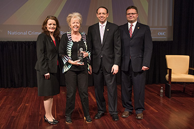 Diana Faugno receives the 2019 Allied Professional Award with (from left) OVC Director Darlene Hutchinson, Deputy Attorney General Rod J. Rosenstein, and Principal Deputy Assistant Attorney General for the Office of Justice Programs Matt M. Dummermuth.