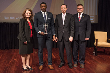 James Shaw, Jr. receives the 2019 Special Courage Award with (from left) OVC Director Darlene Hutchinson, Deputy Attorney General Rod J. Rosenstein, and Principal Deputy Assistant Attorney General for the Office of Justice Programs Matt M. Dummermuth.
