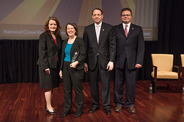 Susan Howley receives the 2019 Crime Victims’ Rights Award with (from left) OVC Director Darlene Hutchinson, Principal Deputy Assistant Attorney General for the Office of Justice Programs Matt M. Dummermuth, and Deputy Attorney General Rod J. Rosenstein.