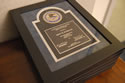 Photo of the 2013 National Crime Victims’ Service Awards plaques displayed on a table.