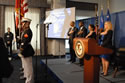 Photo of (from left) U.S. Attorney General Eric H. Holder Jr., listening to the National Anthem with Associate Attorney General Tony West, Assistant Attorney General, Mary Lou Leary, Office of Justice Programs, and Joye E. Frost, Principal Deputy Director, Office for Victims of Crime. Also shown, the Military District of Washington Marine Corps Color Guard.