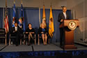 : Photo of U.S. Attorney General Eric H. Holder Jr., addressing attendees at 2013 award ceremony. Also on stage (from left) Associate Attorney General Tony West, Assistant Attorney General Mary Lou Leary, Office of Justice Programs and Joye E. Frost, Principal Deputy Director, Office for Victims of Crime.