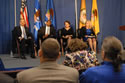 Photo of U.S. Attorney General Eric H. Holder, Jr., on stage with (from left) Associate Attorney General Tony West, Assistant Attorney General Mary Lou Leary, Office of Justice Programs, and Joye E. Frost, Principal Deputy Director, Office for Victims of Crime.