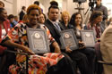 Photo of 2013 award recipient Lisa Wheeler Brown (left), seated with award recipients Santos Garcia and Sonia Cruz holding plaques.
