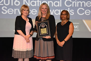 Staff from the National Domestic Violence Hotline accepts the Award for Professional Innovation in Victim Services. Katie Ray-Jones from the National Domestic Violence Hotline accepts the award with (from left) Joye E. Frost, Director, Office for Victims of Crime and Karol V. Mason, Assistant Attorney General.