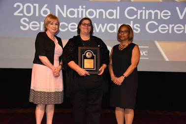 Staff from the Choctaw Nation Victim Services accepts the Award for Professional Innovation in Victim Services. Linda Goodwin Sr., Director Victim Services, accepts the award with (from left) Joye E. Frost, Director, Office for Victims of Crime and Karol V. Mason, Assistant Attorney General.