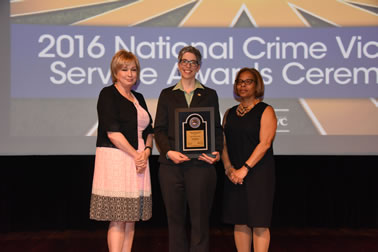 National Crime Victims’ Service Award recipient Anne P. DePrince, Ph.D. accepts the award with (from left) Joye E. Frost, Director, Office for Victims of Crime and Karol V. Mason, Assistant Attorney General.
