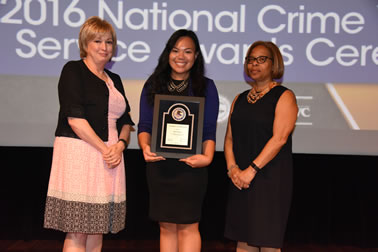 National Crime Victims’ Service Award recipient Miki Nishizawa accepts the award with (from left) Joye E. Frost, Director, Office for Victims of Crime and Karol V. Mason, Assistant Attorney General.