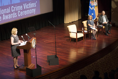 Photo of the welcoming remarks by OVC Director Joye E. Frost. Pictured on stage are Attorney General Eric H. Holder, Jr. and Assistant Attorney General Karol V. Mason.