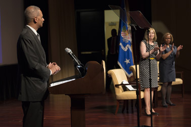 Photo of Attorney General Eric H. Holder, Jr. introduction at the National Crime Victims’ Service Awards Ceremony and receives a standing ovation from Assistant Attorney General Karol V. Mason and OVC Director Joye E. Frost.