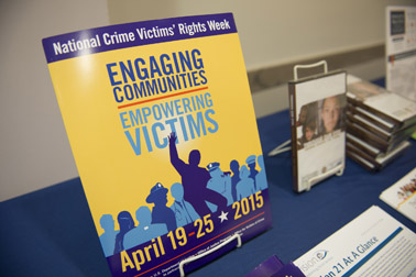 Photo of the materials highlighting new products and information available from OVC at the exhibit table outside the William G. McGowan Theater at the National Crime Victims’ Service Awards Ceremony.