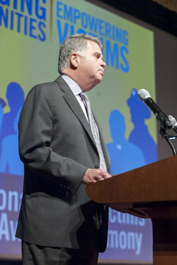 Photo of David S. Ferriero, Archivist of the United States, National Archives and Records Administration, welcomes National Crime Victim Service Award Ceremony attendees to the William G. McGowan Theater.