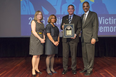 Photo of National Crime Victim Service Award recipient Judge Paul M. Herbert with (from left) Joye E. Frost, Director, Office for Victims of Crime; Karol V. Mason, Assistant Attorney General, and Attorney General Eric H. Holder, Jr.