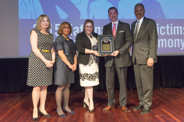 Photo of the Kirsten Gappelberg and Crayton Wendel Webb accepting the Allied Professional Award, on behalf of Mary Kay Inc., with (from left) Joye E. Frost, Director, Office for Victims of Crime; Karol V. Mason, Assistant Attorney General, and Attorney General Eric H. Holder, Jr.