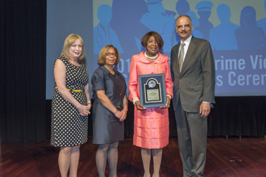 Photo of National Crime Victim Service Award recipient LaWanda Hawkins with (from left) Joye E. Frost, Director, Office for Victims of Crime; Karol V. Mason, Assistant Attorney General, and Attorney General Eric H. Holder, Jr.