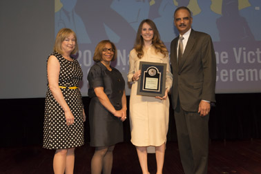 Photo of National Crime Victim Service Award recipient Laurel Wemhoff with (from left) Joye E. Frost, Director, Office for Victims of Crime; Karol V. Mason, Assistant Attorney General, and Attorney General Eric H. Holder, Jr.