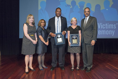 Photo of National Crime Victim Service Award recipients Ronald Cotton and Jennifer Thompson with (from left) Joye E. Frost, Director, Office for Victims of Crime; Karol V. Mason, Assistant Attorney General, and Attorney General Eric H. Holder, Jr.