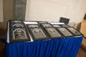 Photo of the 2014 National Crime Victims' Service Awards plaques displayed on a table.