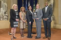 Photo of Margaret Aceves and Julie Marie Renfroe accepting the Award for Professional Innovation in Victim Services for the Rapid DNA Service Team, with Joye E. Frost, Director, Office for Victims of Crime; Karol V. Mason, Assistant Attorney General, Office of Justice Programs; and Associate Attorney General Tony West.